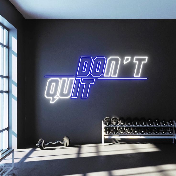 A blue and white gym neon sign with the motivational phrase 'don't quit'