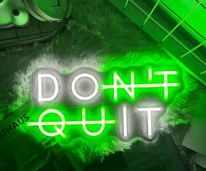 Gym neon sign with the phrase 'Don't quit' in green and white.