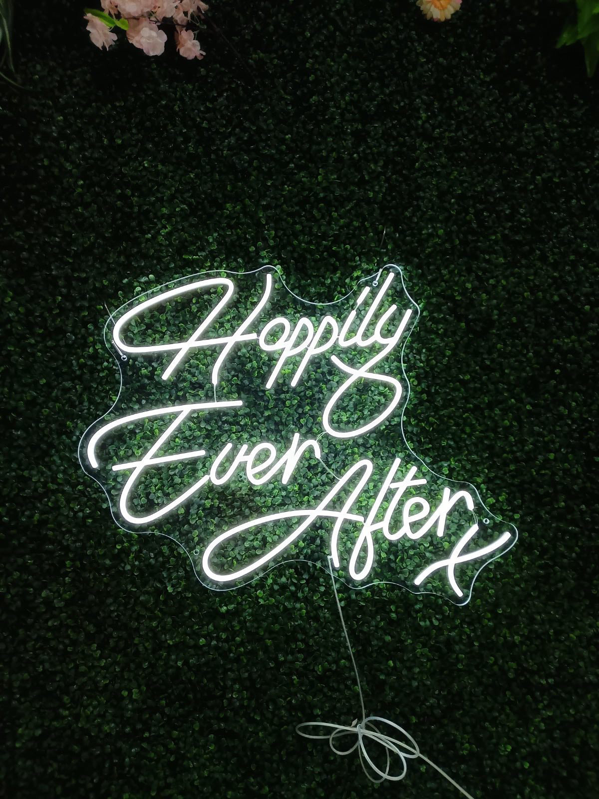 A Happily ever after wedding neon sign against a wedding backdrop