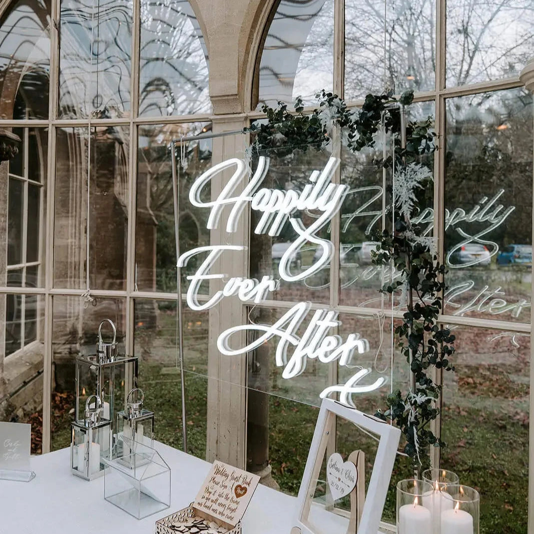 A bright wedding neon sign with the words 'Happily ever after' in a cool white neon glow