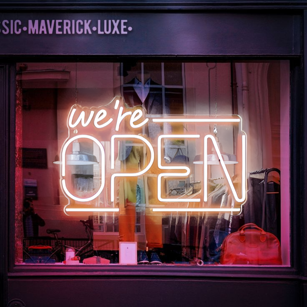 A warm white neon sign displaying the message "We're Open" in bold letters. Ideal for cafes, restaurants, and shops, this sign provides clear and inviting illumination.