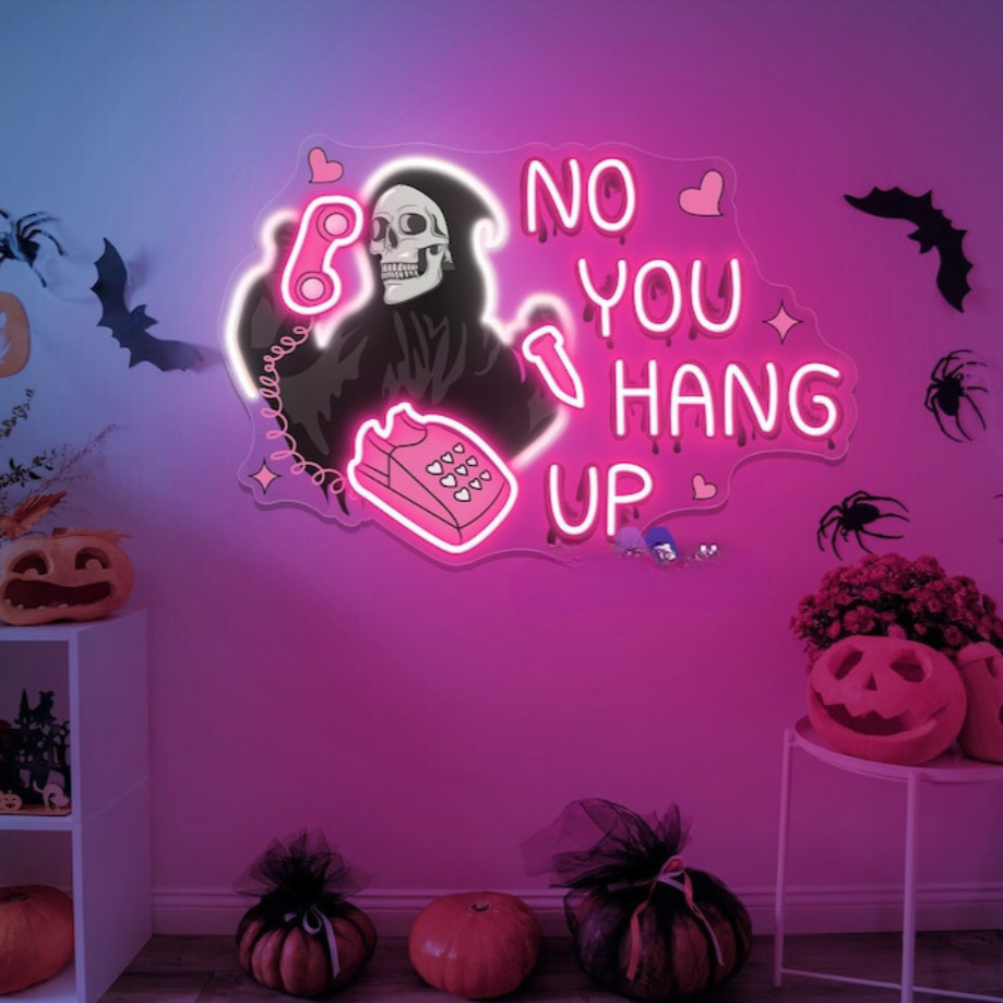 A halloween neon sign with the famous quote from scream in pink neon '' no, you hang up''