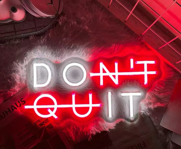 Gym neon sign with the phrase 'Don't quit' in red and white.