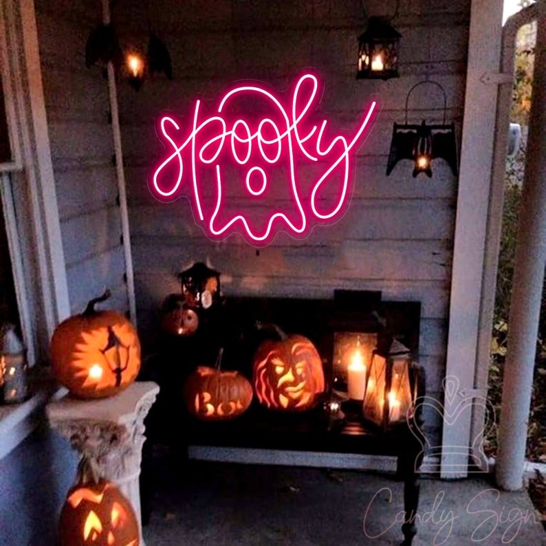 A spooky Halloween neon sign of a ghost in pink 